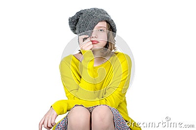 Portrait of a cute teen girl, who pulls his cap over her face. Stock Photo