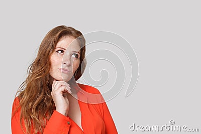 Portrait of cute thinking woman looking up on white background Stock Photo