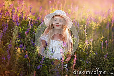 Portrait of cute young girl with long hair in a hat at sunset Stock Photo