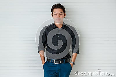 Portrait of a cute young and handsome Asian man in casual shirt pose to camera with warm smile and self trust Stock Photo