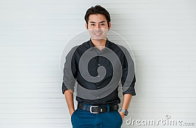 Portrait of a cute young and handsome Asian man in casual shirt pose to camera with warm smile and self trust Stock Photo