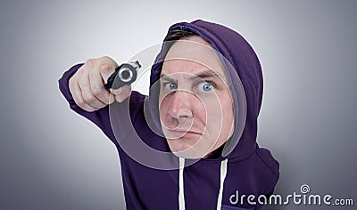 Portrait dangerous man in a hood with gun Stock Photo