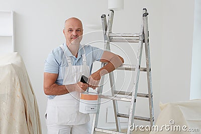 Portrait Of Decorator Painting Room Stock Photo