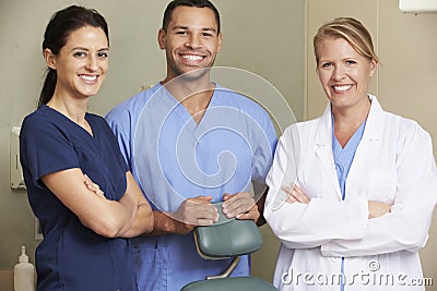 Portrait Of Dentist And Dental Nurses In Surgery Stock Photo