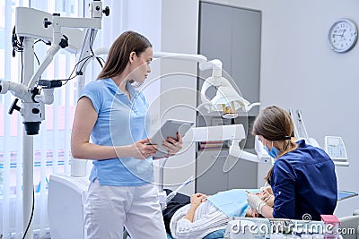 Portrait of dentist doctor with digital tablet Stock Photo