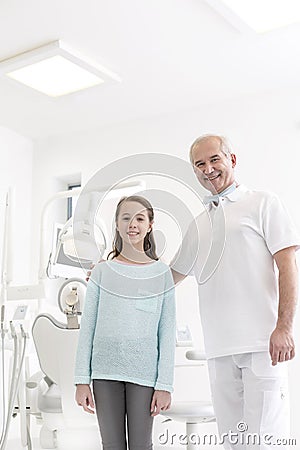 Portrait of dentist and girl patient at dental clinic Stock Photo