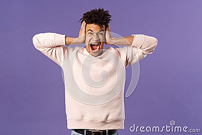 Portrait of depressed, pissed-off young college student, man screaming and shut ears in denial, feel distressed, having Stock Photo