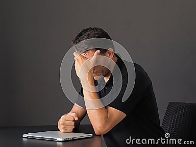 Portrait of depressed and tired young caucasian man, hold hands on face and sighing, feel regret Stock Photo