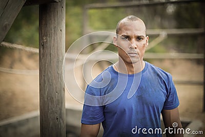 Portrait of determined man standing during obstacle course Stock Photo