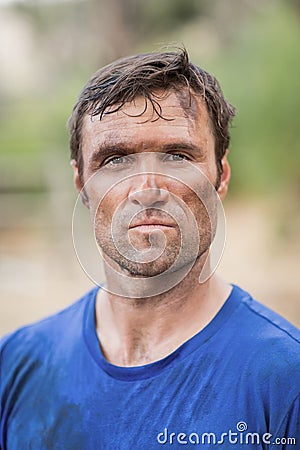 Portrait of determined man standing during obstacle course Stock Photo