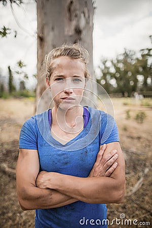 Portrait of determined woman standing with arms crossed during obstacle course Stock Photo