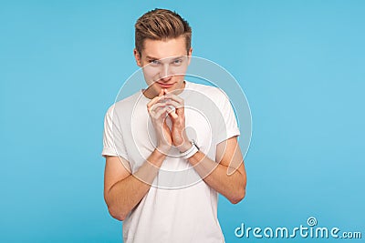 Portrait of devious sneaky man holding hands together while thinking over clever cunning idea Stock Photo