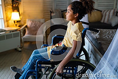 Portrait of disabled black girl with wheelchair at home Stock Photo