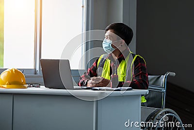 Portrait disabled person sitting on wheelchair wear mask working in the office Stock Photo