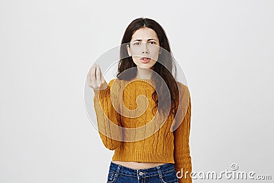Portrait of disappointed frowning caucasian woman showing italian what do you want gesture, being angry or irritated Stock Photo