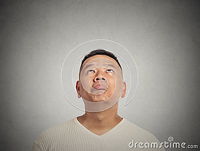 Portrait disappointed young man looking up Stock Photo