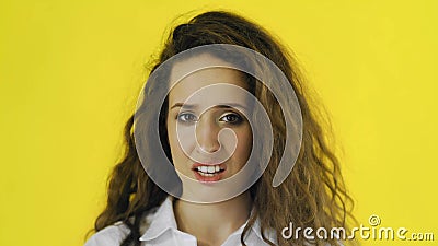 Portrait of discontent woman expressing aversion and demonstrating her disgust in Studio with yellow Background. Stock Photo