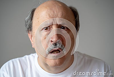 Portrait of disorientated and confused old man suffering from Alzheimer Stock Photo