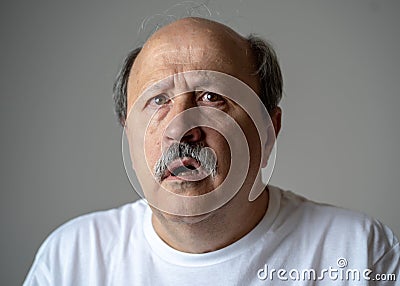 Portrait of disorientated and confused old man suffering from Alzheimer Stock Photo