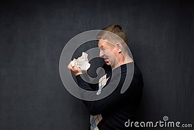 Portrait of displeased man tearing paper sheet Stock Photo
