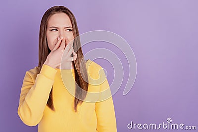 Portrait of displeased tired mad lady hold cover nose look empty space disgusted smell on violet background Stock Photo