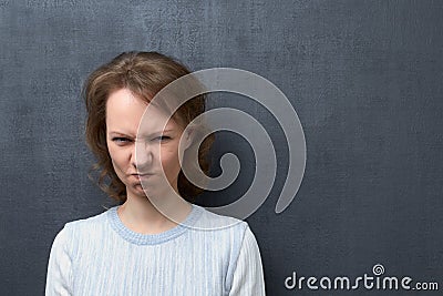 Portrait of dissatisfied girl, seeing or smelling something unpleasant Stock Photo