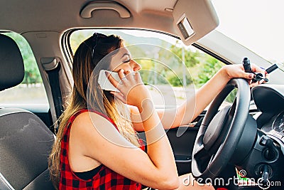 Young beautiful reckless woman using smartphone while driving car Stock Photo