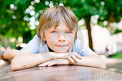 Portrait of dreaming little boy 7 years old outdoors Stock Photo