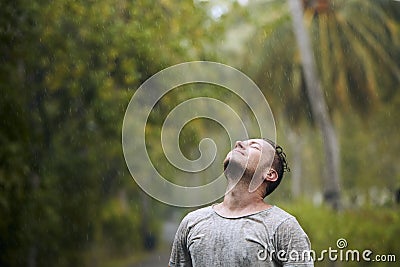 Portrait of drenched man in rain Stock Photo