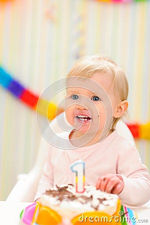 Portrait of eat smeared baby with birthday cake Stock Photo