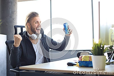 Portrait of ecstatic gamer guy in headphones screaming and rejoicing while playing video games on computer Stock Photo
