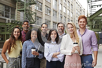 Portrait of eight friendly coworkers outside their workplace Stock Photo