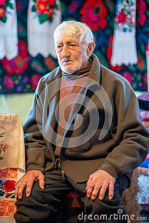 Portrait of an elder man in traditional old home and traditional clothes, Roumania Maramures County Editorial Stock Photo