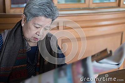 Portrait of elder woman, elderly female, senior read newspaper. Stock Photo