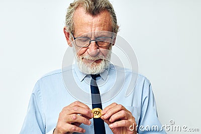 Portrait elderly man Bitcoin cryptocurrency in the hands of a financier isolated background Editorial Stock Photo