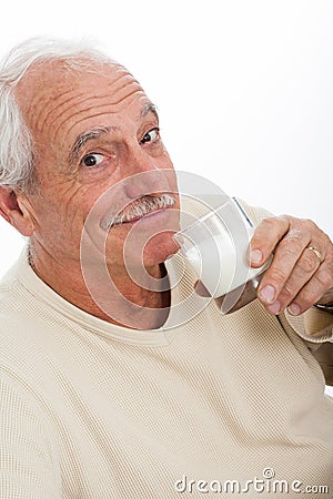 Elderly man drinking milk Stock Photo