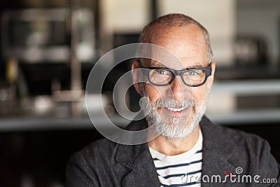 Portrait Of A Elderly Man Smiling At The Camera Stock Photo