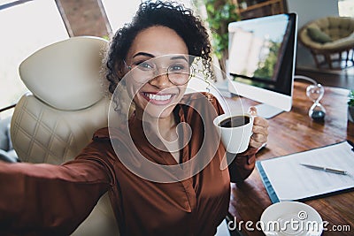 Portrait of elegant attractive recruiter lady sit chair make selfie hand hold fresh aroma coffee mug workplace indoors Stock Photo