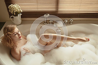 Elegant beautiful woman relaxing in a spa bath Stock Photo