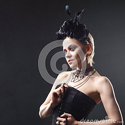 Portrait of an elegant Gothic blonde woman. Girl in wreath of black flowers and black cloak Stock Photo