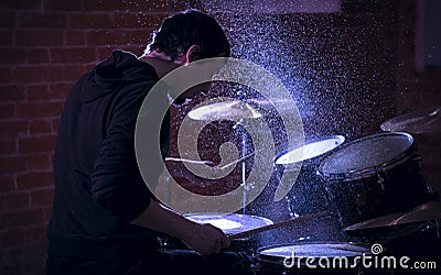 Portrait of emotional drummer rehearsing on drums. Stock Photo