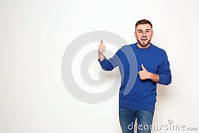 Portrait of emotional man showing thumbs up gesture Stock Photo