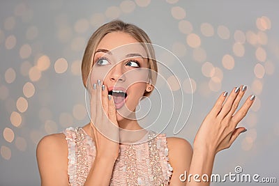 Portrait of emotional young woman with shiny manicure on blurred background Stock Photo