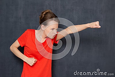 Portrait of enraged dissatisfied girl holding fists clenched Stock Photo