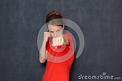 Portrait of enraged dissatisfied girl holding fists clenched Stock Photo