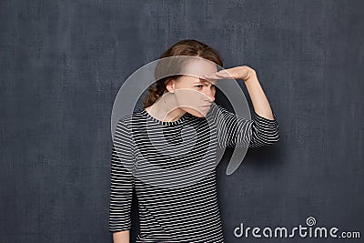 Portrait of enraged irritated girl looking far away with displeasure Stock Photo