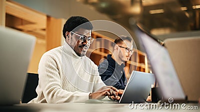 Portrait of Enthusiastic Black Man Turning on his Laptop and Starting his Work Day at the Office Stock Photo