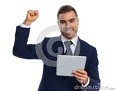 portrait of enthusiastic man holding fist in the air and smiling Stock Photo