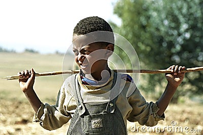 Portrait Ethiopian Oromo boy with stick Editorial Stock Photo
