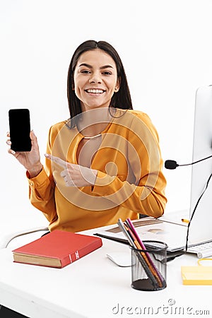 Portrait of european customer supporter woman holding smartphone while working in call center Stock Photo